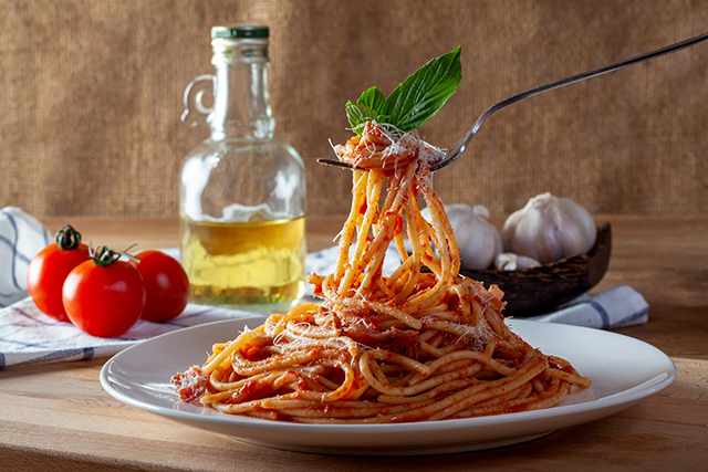 Spaghetti in a dish on a wooden background