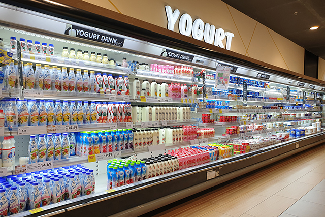 View of the huge fridge with various brands of dairy and yogurt